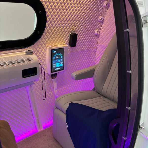 Interior of clinical-grade 2.0 ATA hard-shell hyperbaric oxygen therapy chamber — dual recliners with control panel