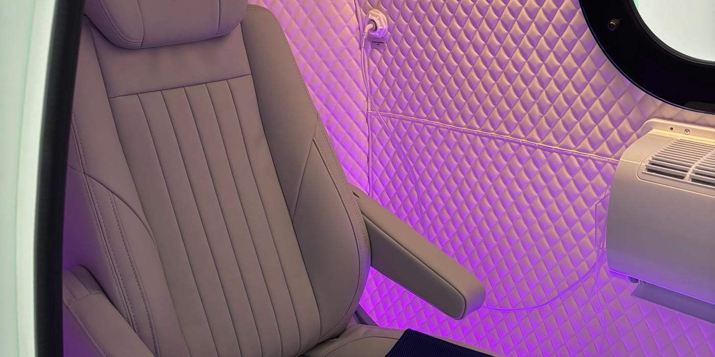 Interior of clinical-grade 2.0 ATA hard-shell hyperbaric oxygen therapy chamber — single recliner with ambient lighting